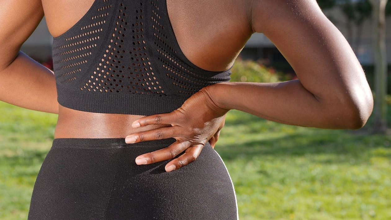 The symptoms of back pain can vary from person to person but may include stiffness, tightness (Kindel Media/ Pexels)
